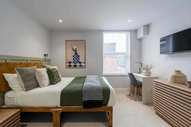 A contemporary and well-presented bedroom featu...