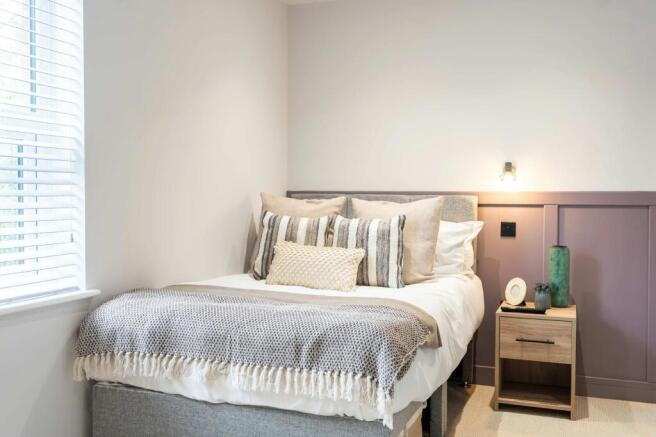 A bright, well-maintained master bedroom featur...