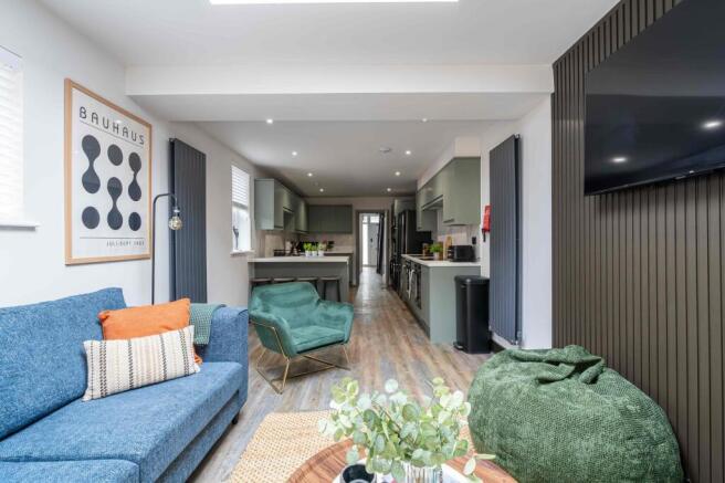 Bright and stylish living room featuring a comf...