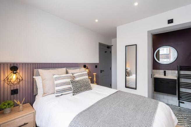 A modern and stylish master bedroom featuring a...