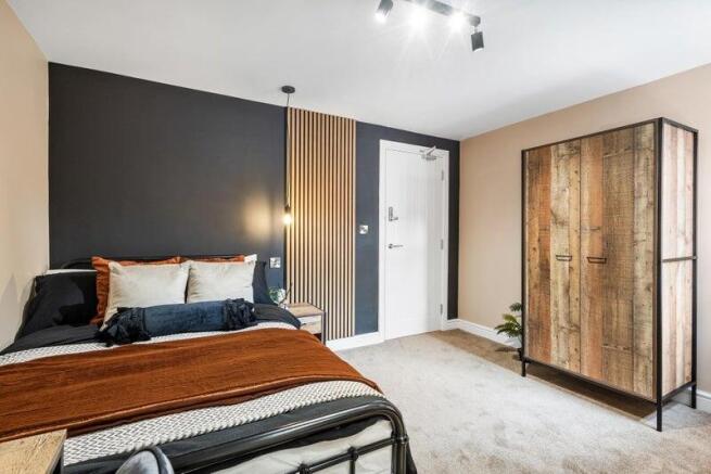 A stylish double bedroom featuring a comfortabl...