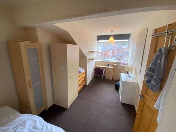 A cozy and well-maintained bedroom with natural...