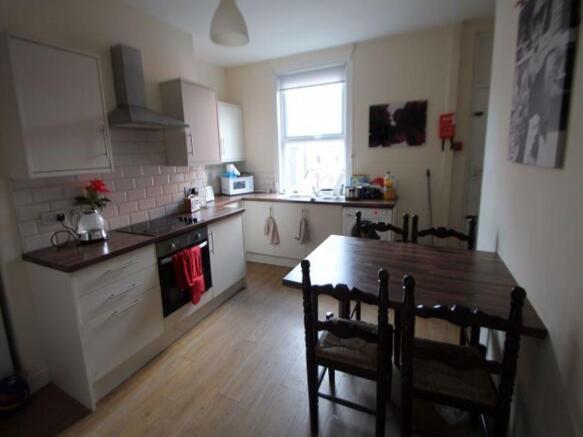 Bright and welcoming kitchen with ample natural...