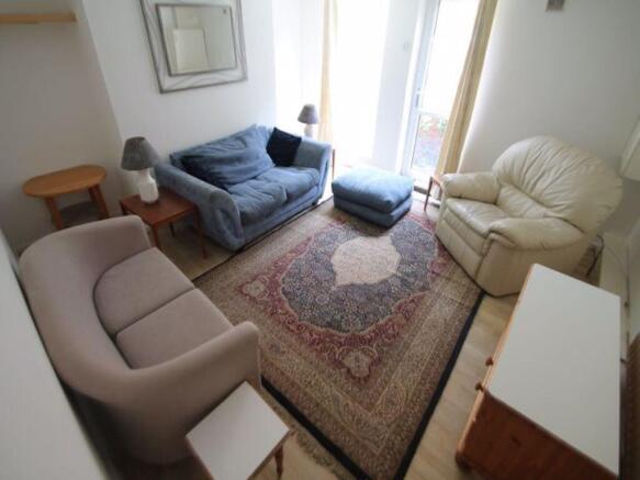 A bright and inviting living room featuring a v...