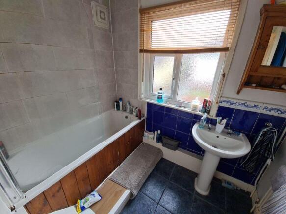 A well-maintained bathroom with a white sink an...