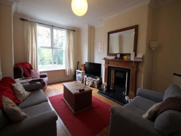 A cozy and well-lit living room featuring a com...