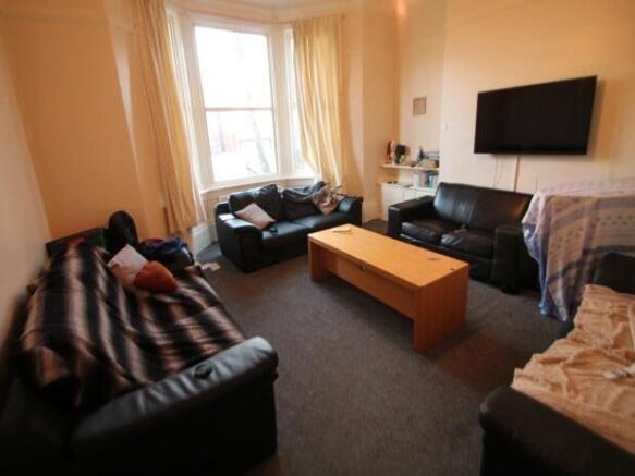 A spacious and welcoming living room with ample...