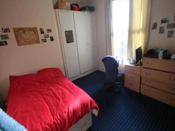 A cozy bedroom featuring a comfortable bed with...