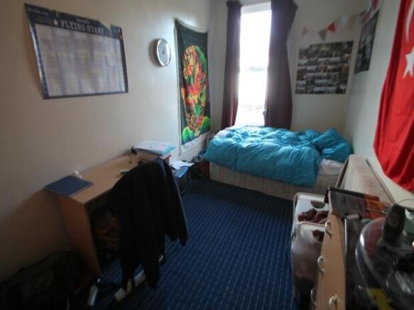 A spacious and well-lit bedroom featuring a com...