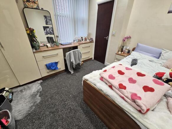 A spacious and inviting master bedroom featurin...