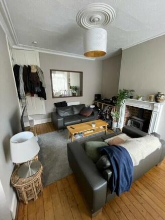 A cozy and well-maintained living room with amp...