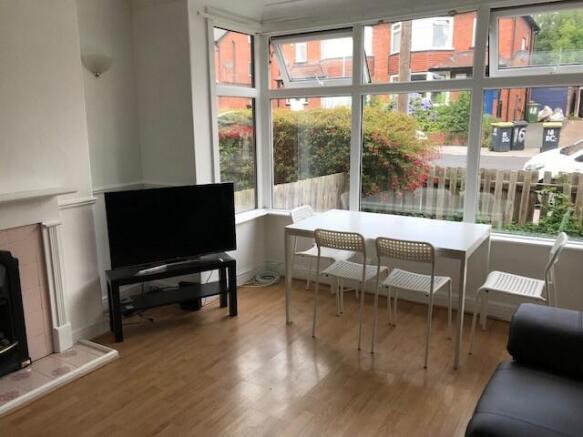 A bright and spacious living room with large wi...