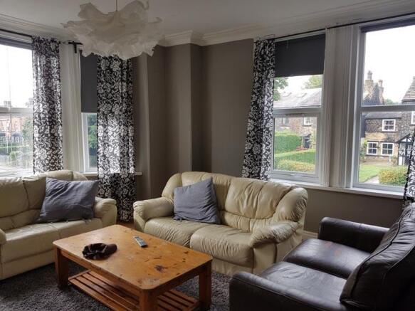 A spacious and inviting living room filled with...