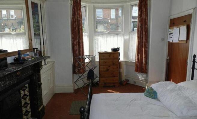 A cozy and well-maintained bedroom featuring a ...