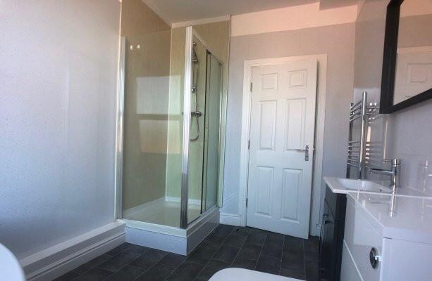 A clean and well-maintained bathroom with a gla...