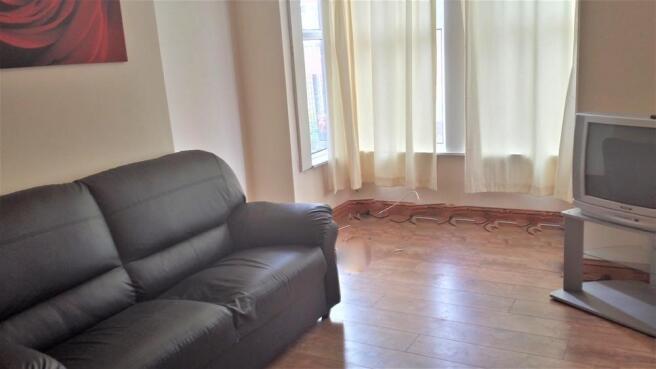 Cozy living room featuring a comfortable black ...