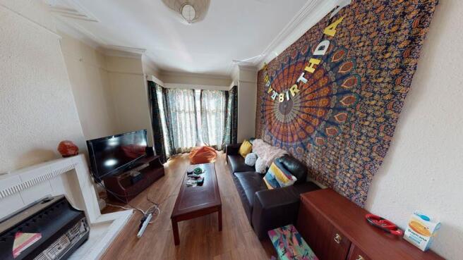 A spacious and well-lit contemporary living roo...