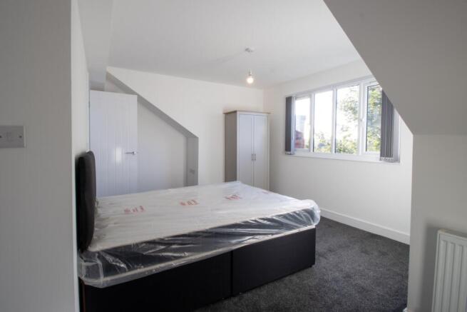 Bright and spacious double bedroom with a large...