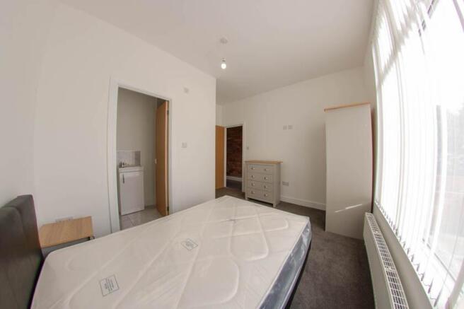 Bright and spacious bedroom with a large window...