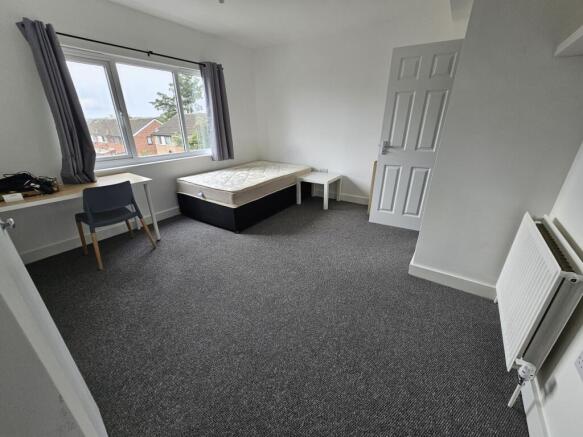 A bright and spacious double bedroom featuring ...
