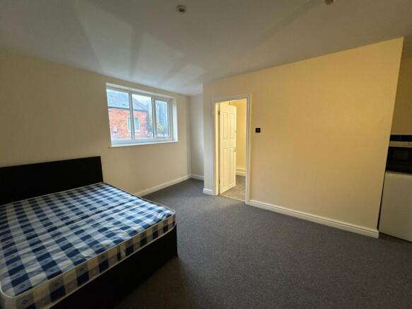 A cozy bedroom with a large window providing na...