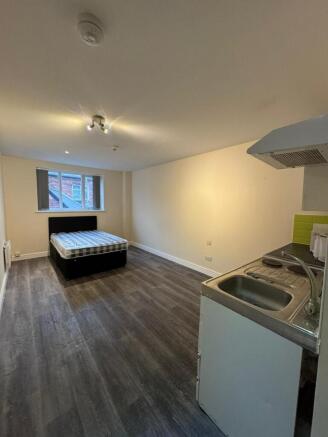 A bright, spacious living area with a large win...
