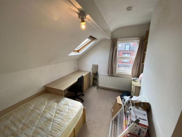 A cozy single bedroom with a comfortable bed, n...