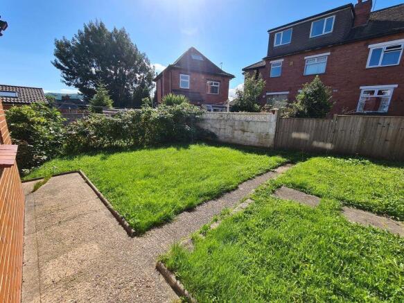 A bright and well-maintained garden space featu...