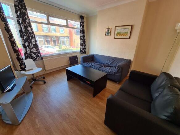 A cozy and well-maintained living room featurin...