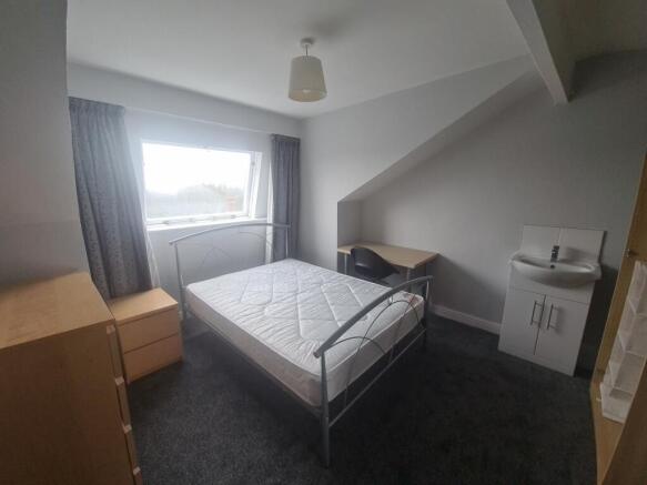 A bright and modern bedroom featuring a comfort...