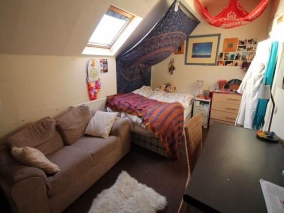 A cozy living room with a comfortable sofa, a w...