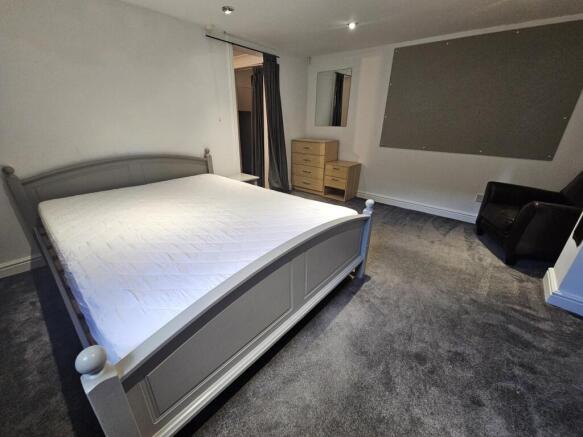 A spacious, well-maintained double bedroom feat...