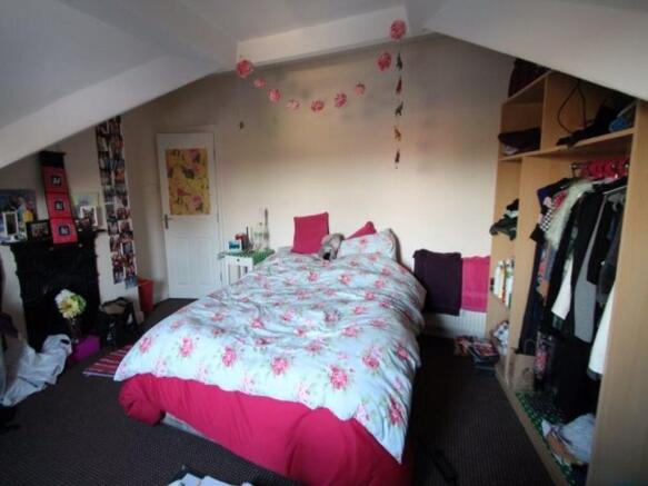 A spacious and well-lit master bedroom featurin...