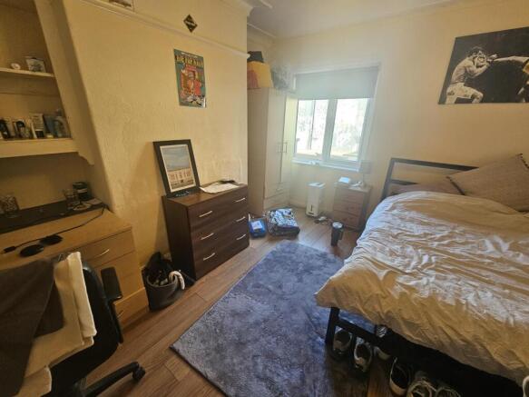 A spacious and well-lit master bedroom featurin...