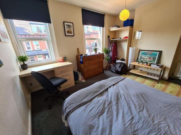 A bright and welcoming double bedroom featuring...
