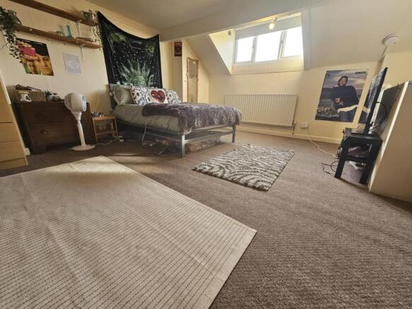 Bright and spacious master bedroom featuring a ...