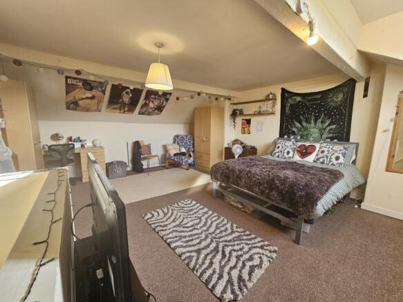 A spacious master bedroom featuring a large dou...
