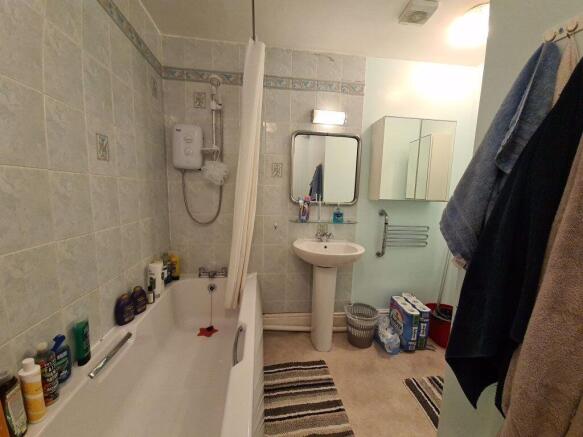 A well-maintained bathroom featuring a bathtub,...