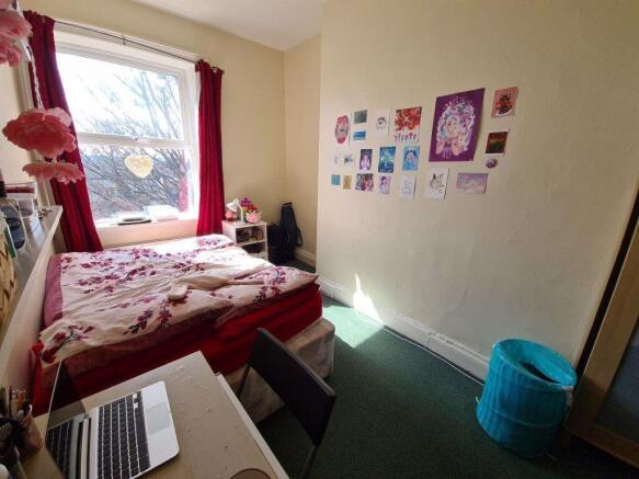 A cozy student bedroom featuring a double bed w...