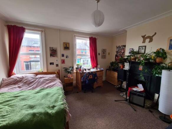 A spacious, cozy bedroom featuring a large doub...