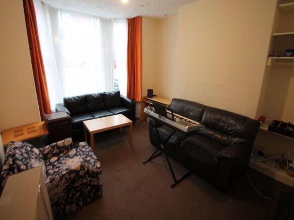 A well-lit living room featuring comfortable se...