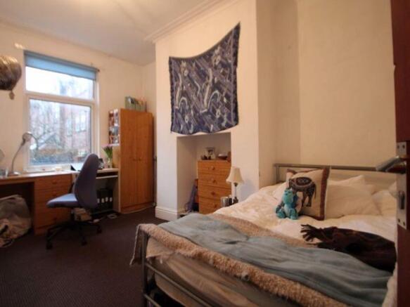 A cozy and inviting master bedroom featuring a ...