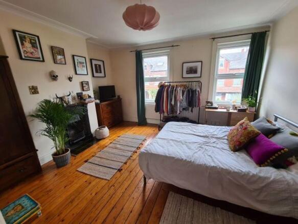 A bright and welcoming living room featuring la...