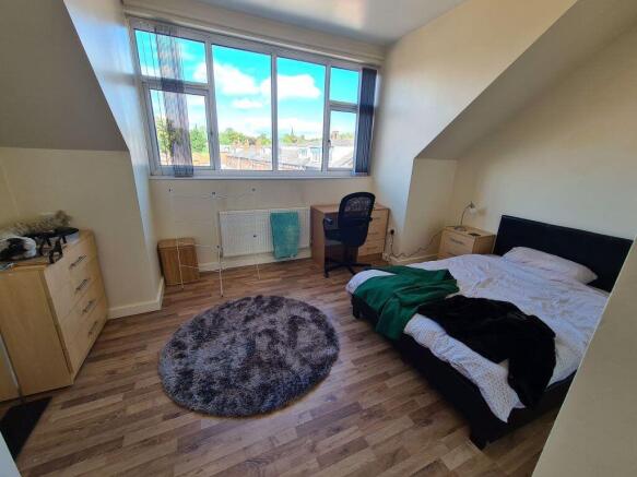 Bright and airy double bedroom featuring a comf...