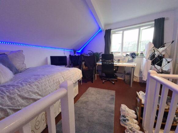 A spacious and well-lit bedroom featuring a com...