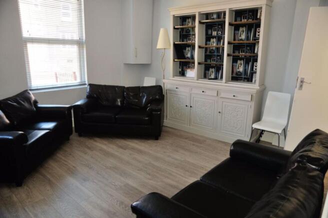 A spacious and modern living room with large wi...