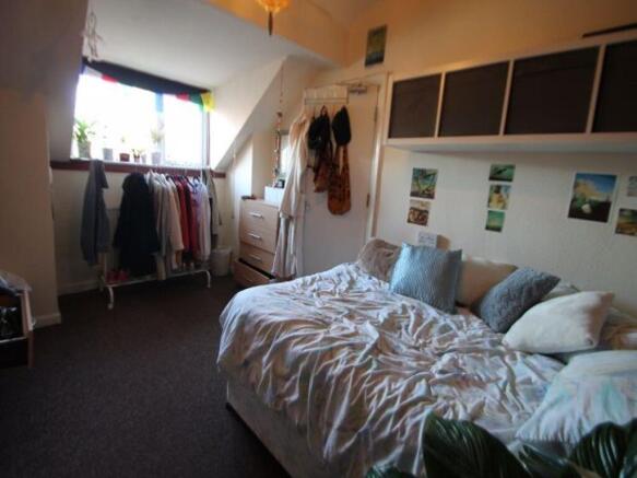 A spacious and bright master bedroom featuring ...