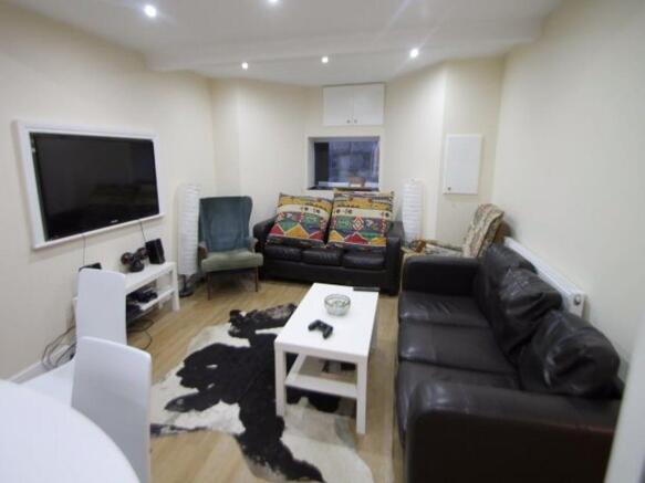 A cozy and well-lit living room featuring comfo...