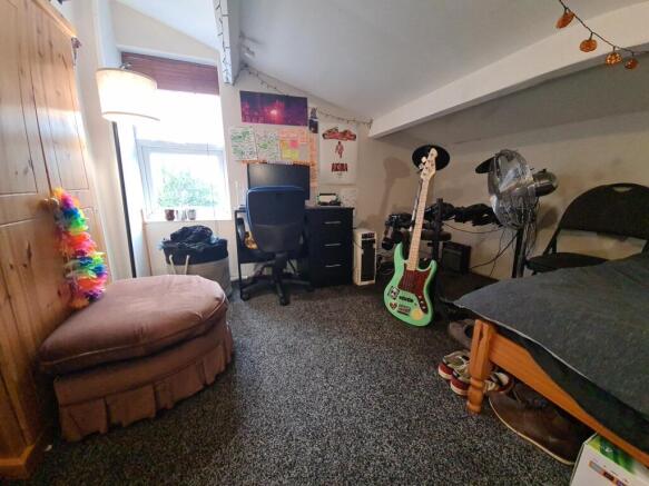 A spacious and well-lit living area with comfor...