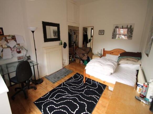 A spacious and inviting master bedroom featurin...